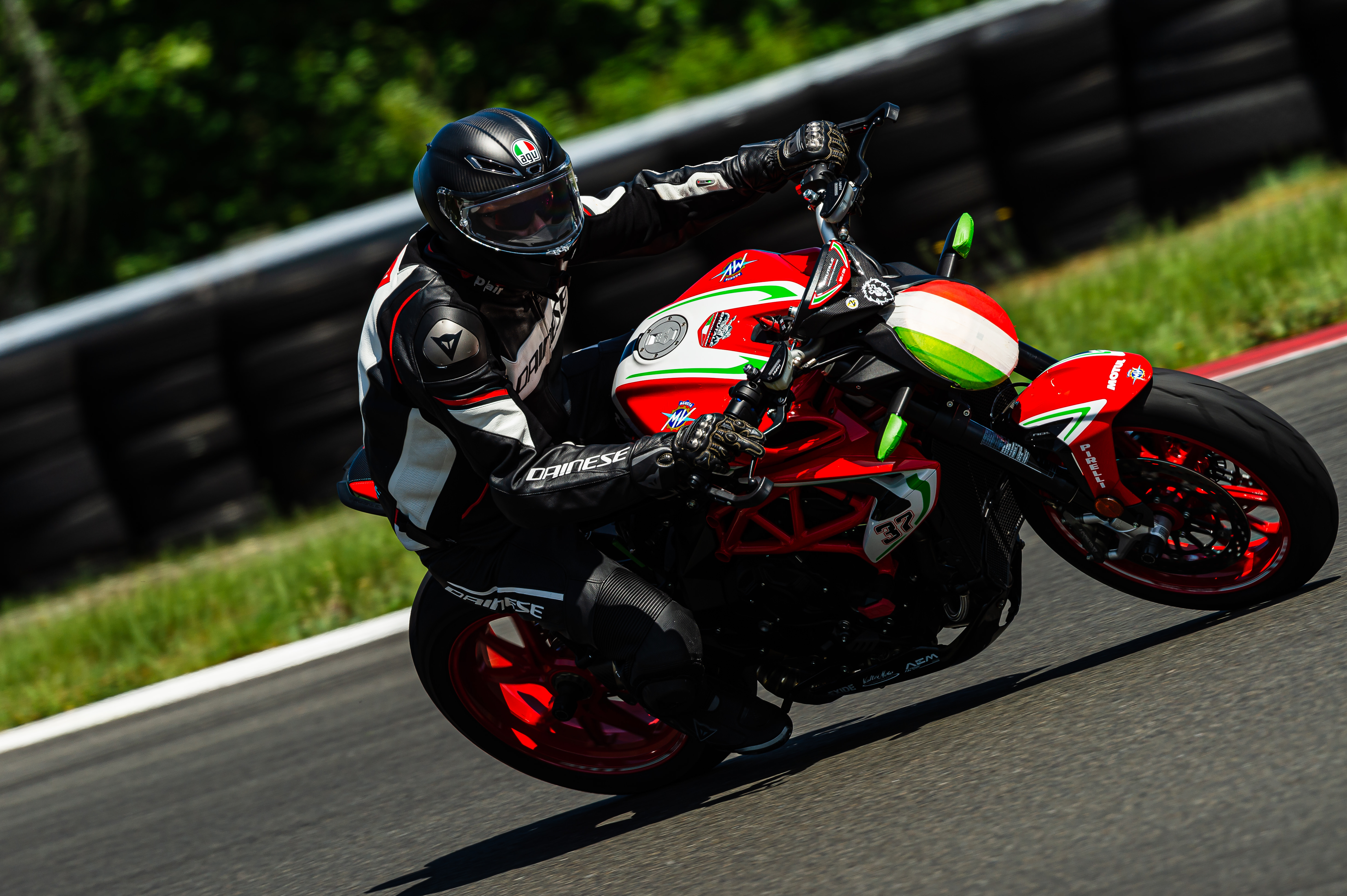An MV Agusta motorcycle in full lean at Ridge Motorsports Park, rider committed to a left turn at speed